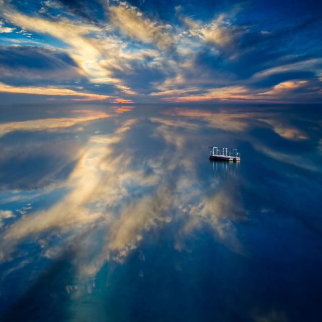 a boat floating in the water - Download Free Stock Photos Pikwizard.com