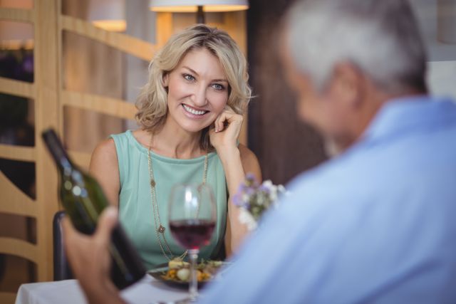 Mature couple having meal and red wine in restaurant