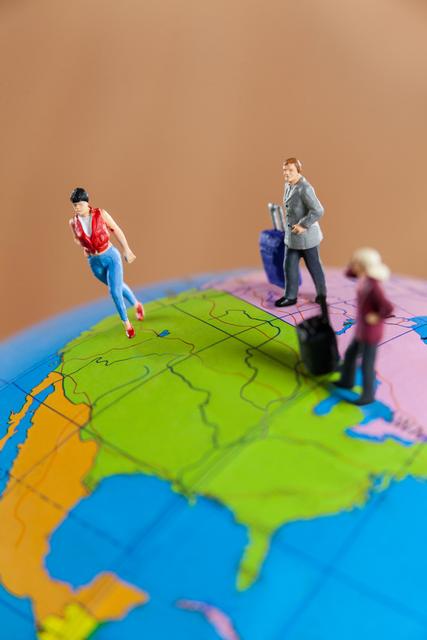Miniature people travelling on globe - Download Free Stock Photos Pikwizard.com