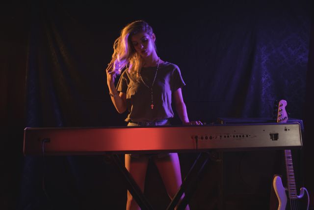Female musician playing piano in nightclub - Download Free Stock Photos Pikwizard.com