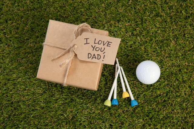 Fathers day gift box with text by golf ball on field - Download Free Stock Photos Pikwizard.com