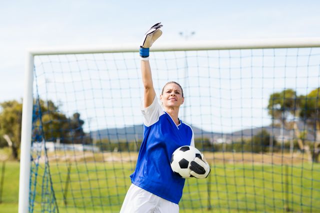 Female goalkeeper holding a ball and gesturing - Download Free Stock Photos Pikwizard.com