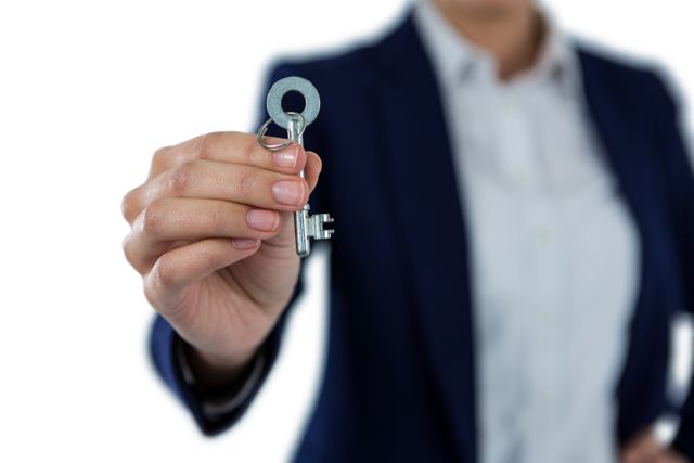 Mid section of businesswoman showing new house key - Download Free Stock Photos Pikwizard.com