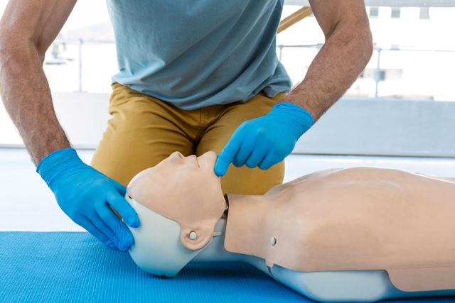 Mid section of paramedic practising resuscitation on dummy - Download Free Stock Photos Pikwizard.com