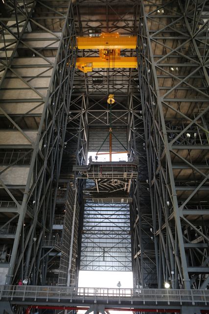 A heavy-lift crane lifts the second half of the C-level work platforms, C north, for NASA’s Space Launch System (SLS) rocket, high up from the transfer aisle of the Vehicle Assembly Building (VAB) at NASA's Kennedy Space Center in Florida. The C platform will be moved into High Bay 3 for installation on the north side of High Bay 3. The C platforms are the eighth of 10 levels of work platforms that will surround and provide access to the SLS rocket and Orion spacecraft for Exploration Mission 1. The Ground Systems Development and Operations Program is overseeing upgrades and modifications to VAB High Bay 3, including installation of the new work platforms, to prepare for NASA’s Journey to Mars. 
