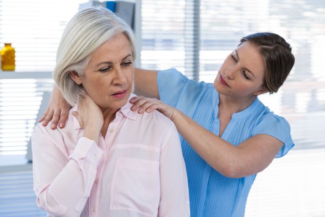 Doctor massaging a patient's shoulder - Download Free Stock Photos Pikwizard.com