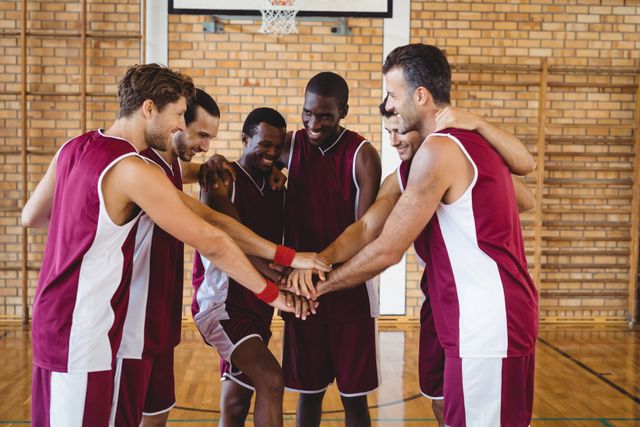 Team of basketball players stacking hands - Download Free Stock Photos Pikwizard.com