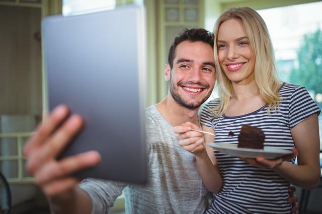 Smiling couple taking selfie from digital tablet - Download Free Stock Photos Pikwizard.com