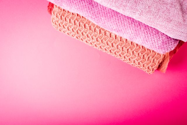 Composition of close up of colourful clothes lying over pink background - Download Free Stock Photos Pikwizard.com