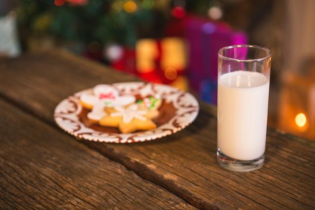 Gingerbread cookies with a glass of milk on wooden table - Download Free Stock Photos Pikwizard.com