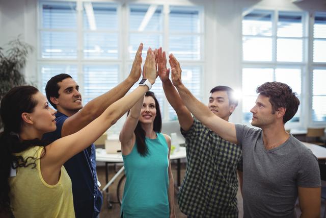 Group of business executives giving high five - Download Free Stock Photos Pikwizard.com