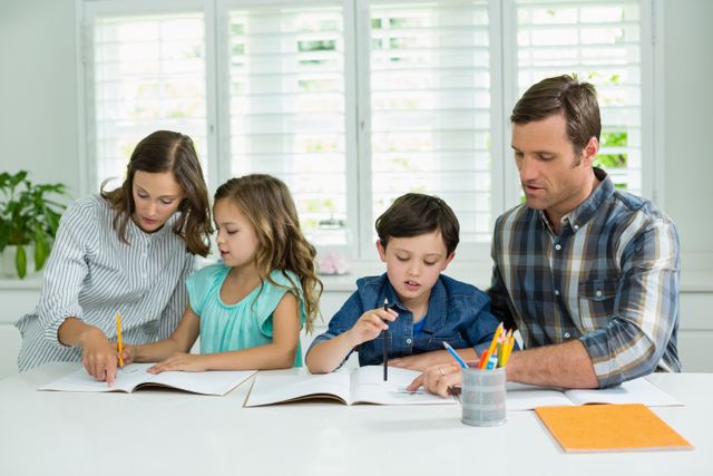 Siblings getting help with homework from parents - Download Free Stock Photos Pikwizard.com