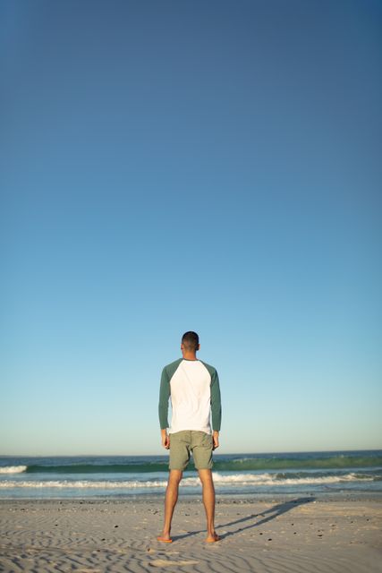Man standing on the beach - Download Free Stock Photos Pikwizard.com