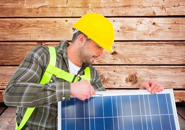 Worker fixing solar panel against wooden background - Download Free Stock Photos Pikwizard.com