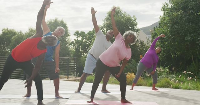 Senior diverse people practicing yoga in garden at retirement home. healthy, active retirement and body inclusivity.