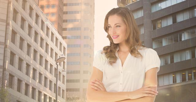 Digital composite image of female executive standing with arms crossed against city background