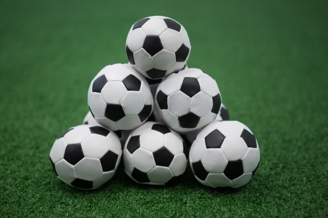 Stack of piled up football soccer balls - Download Free Stock Photos Pikwizard.com