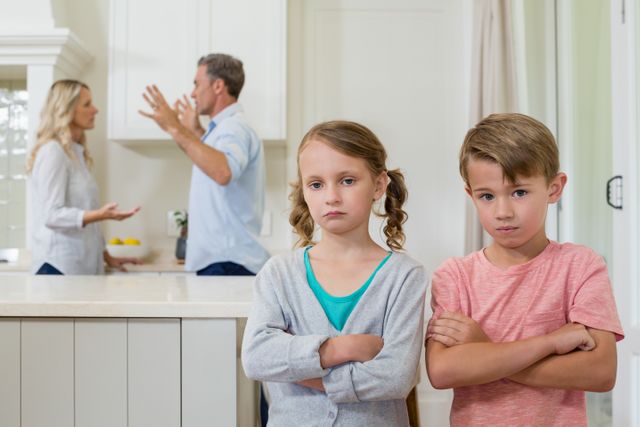 Sad sibling standing with arms crossed while parents arguing each other - Download Free Stock Photos Pikwizard.com