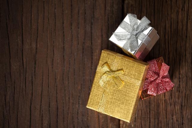 Wrapped gift boxes on wooden table - Download Free Stock Photos Pikwizard.com