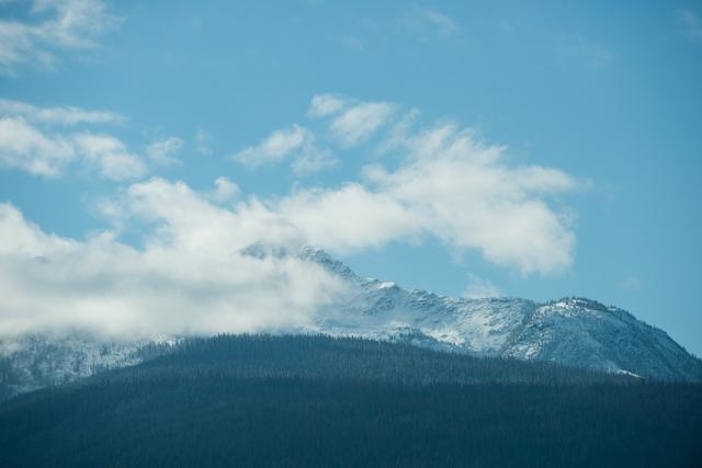View of beautiful snowy mountain range and clouds