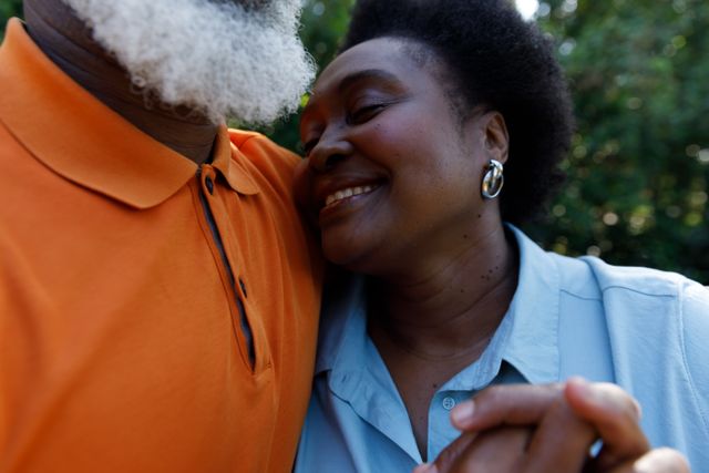 Close up of an old african-american couple slightly hugging each other with their hands clasped toge - Download Free Stock Photos Pikwizard.com