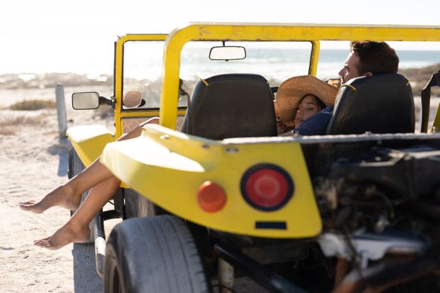 Happy caucasian couple relaxing in beach buggy on sunny beach - Download Free Stock Photos Pikwizard.com