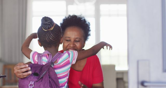 Image of african american granddaughter with schoolbag coming home and hugging happy grandmother - Download Free Stock Photos Pikwizard.com