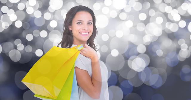 Happy woman carrying shopping bags over bokeh - Download Free Stock Photos Pikwizard.com