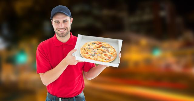 Delivery man holding pizza in box - Download Free Stock Photos Pikwizard.com