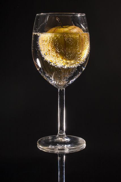 Clear Wine Glass Filled With Clear Beverage With Yellow Round Fruit - Download Free Stock Photos Pikwizard.com