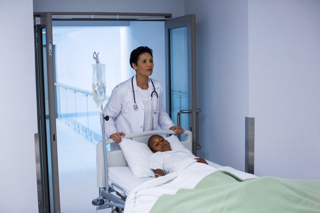 Doctor pushing emergency stretcher bed in corridor - Download Free Stock Photos Pikwizard.com