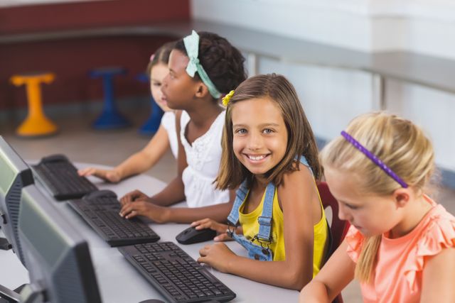 Schoolgirls using computer in classroom - Download Free Stock Photos Pikwizard.com
