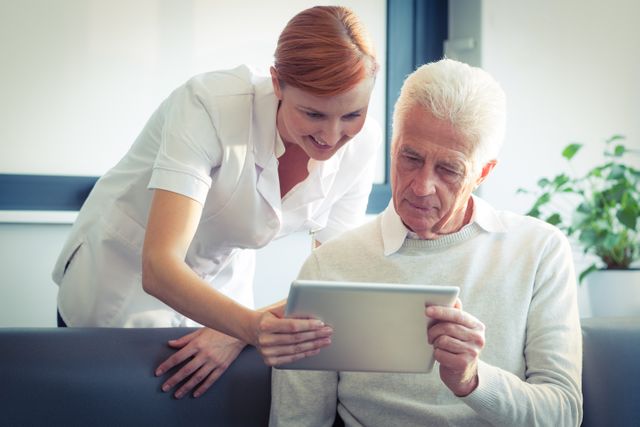 Female nurse showing medical report to senior man on digital tablet- Download Free Stock Photos Pikwizard.com