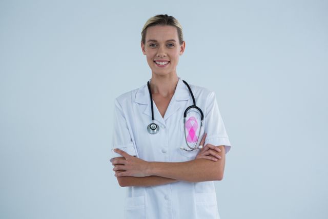 Portrait of female doctor with Breast Cancer Awareness ribbon - Download Free Stock Photos Pikwizard.com
