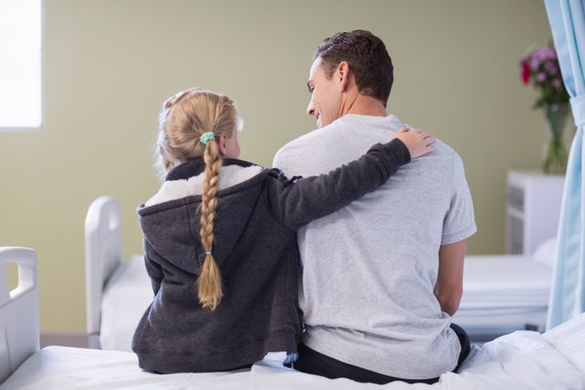 Rear view of daughter comforting her sick father - Download Free Stock Photos Pikwizard.com