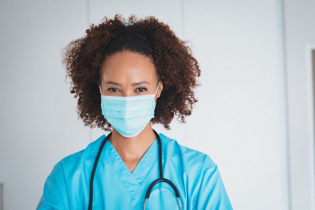 Portrait of mixed race doctor with stetoscope wearing face mask - Download Free Stock Photos Pikwizard.com