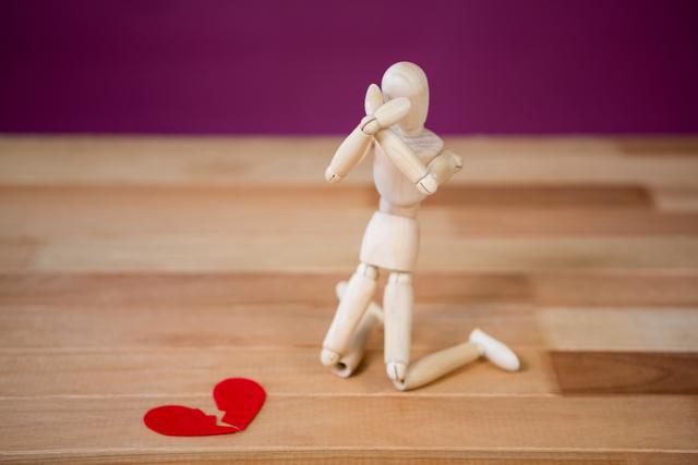 Figurine kneeling in front of broken heart - Download Free Stock Photos Pikwizard.com