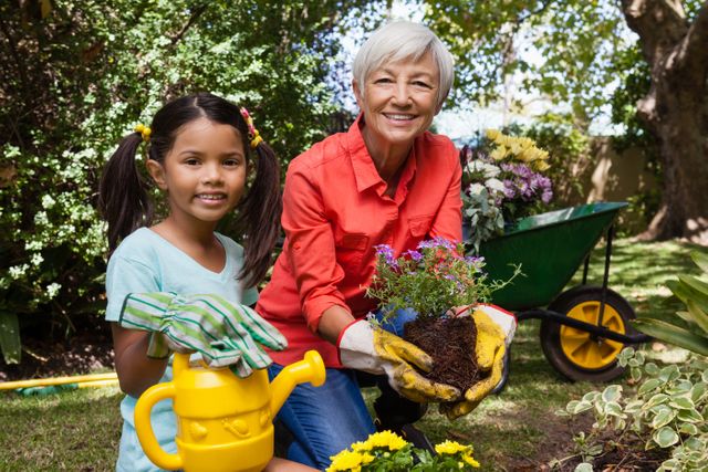 Portrait of smiling girl and grandmother gardening - Download Free Stock Photos Pikwizard.com