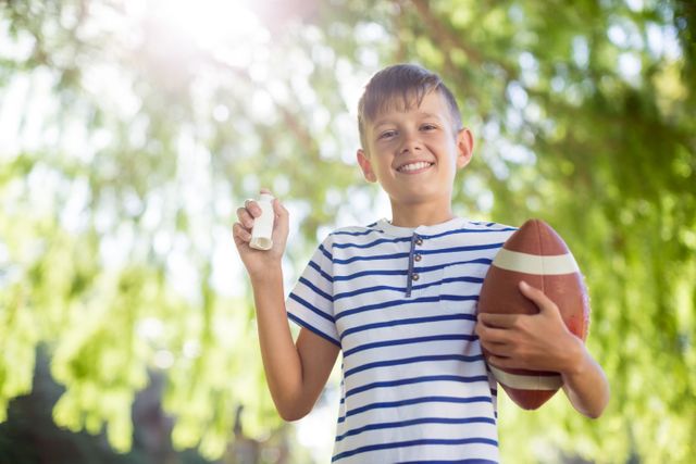 Boy holding asthma inhaler and a rugby ball - Download Free Stock Photos Pikwizard.com