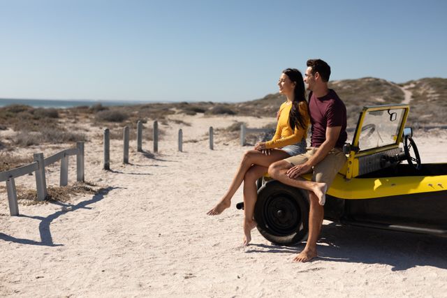 Happy caucasian couple sitting on beach buggy at sunny beach embracing and admiring the view - Download Free Stock Photos Pikwizard.com