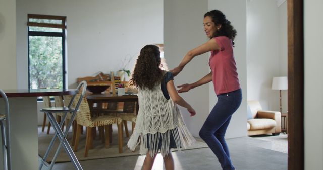Happy mixed race mother and daughter dancing in living room - Download Free Stock Photos Pikwizard.com