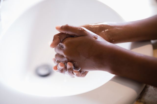 Cropped image of person washing hands at sink - Download Free Stock Photos Pikwizard.com