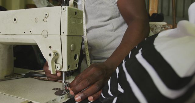 Midsection of african american male tailor using sewing machine in workshop - Download Free Stock Photos Pikwizard.com