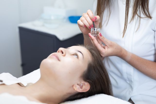Female caucasian beautician preparing facial treatment for caucasian woman - Download Free Stock Photos Pikwizard.com