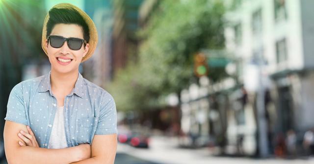 Cheerful man in sunglasses and straw hat standing with arms crossed in a street - Download Free Stock Photos Pikwizard.com