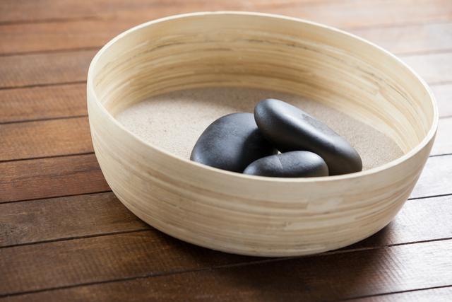 Three pebble stone on a wooden bowl - Download Free Stock Photos Pikwizard.com