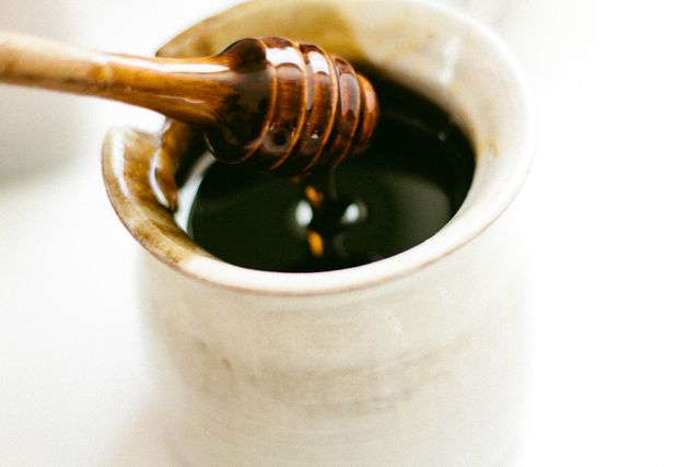 a spoon being dipped into a jar of honey - Download Free Stock Photos Pikwizard.com