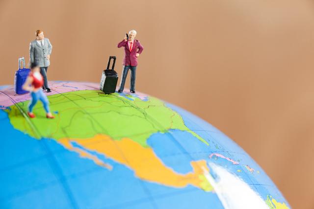 Miniature people travelling on globe - Download Free Stock Photos Pikwizard.com