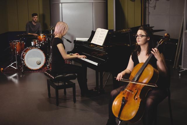 Group of students playing double bass, drum set and piano - Download Free Stock Photos Pikwizard.com