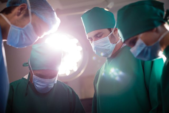 Medical team performing operation in operating room - Download Free Stock Photos Pikwizard.com
